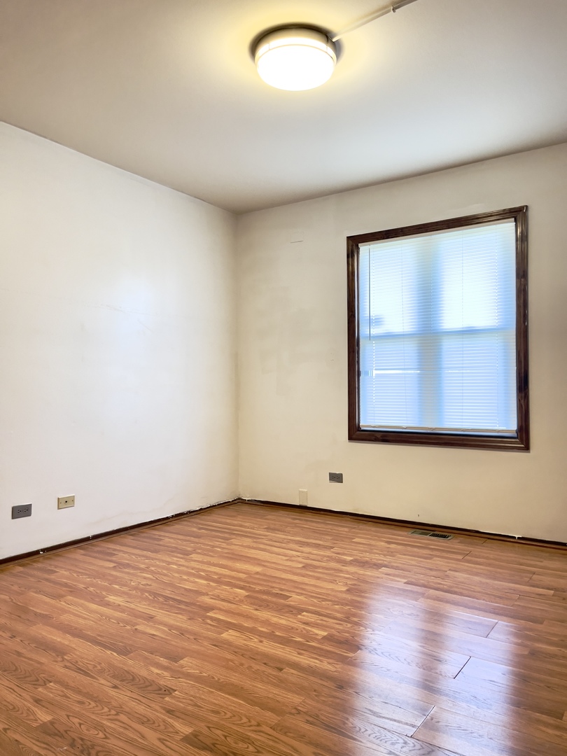 817 74th Street Downers Grove, IL 60516 - Photo 15 of 19 an empty room with wooden floor and windows
