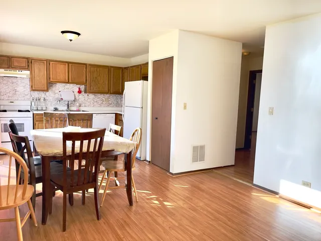 a kitchen with a table and chairs