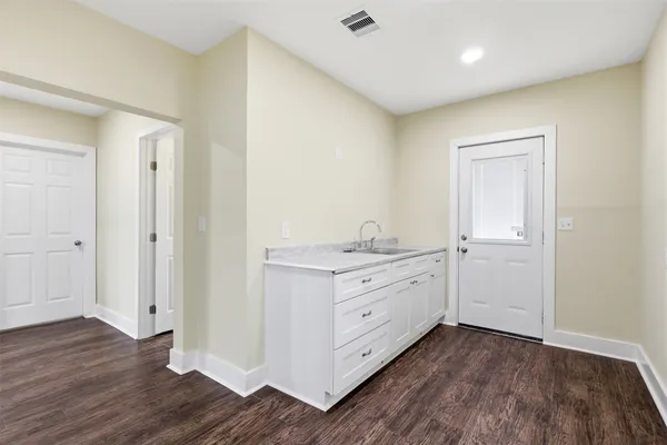 a room with a dresser and wooden floor