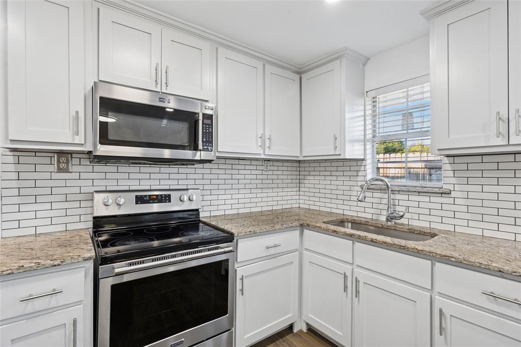 3000 Burchill Road South Fort Worth, TX 76105 - Photo 11 of 26 a kitchen with cabinets stainless steel appliances a sink and a window