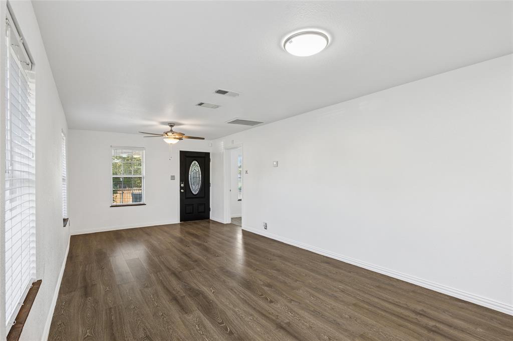 3000 Burchill Road South Fort Worth, TX 76105 - Photo 5 of 26 an empty room with wooden floor and windows