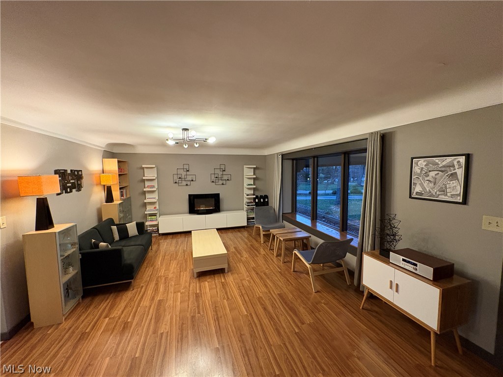 17583 Shurmer Road Strongsville, OH 44136 - Photo 11 of 50 Spacious living area featuring wood-finish flooring, a contemporary ceiling light fixture, and a large bay window
