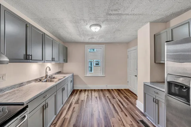 a kitchen with a sink stove and cabinets