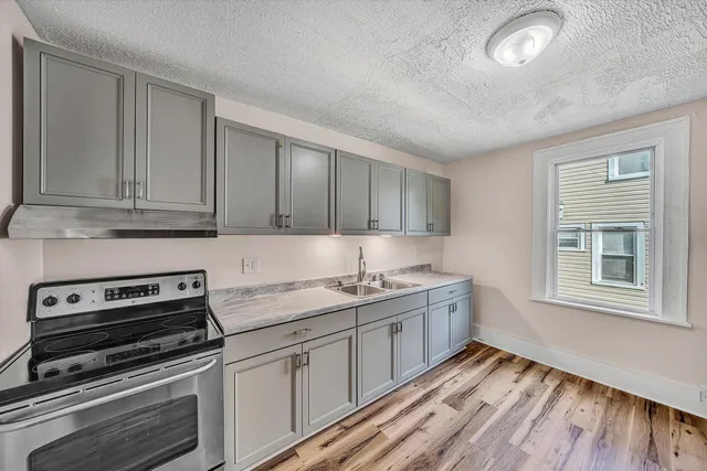 a kitchen with white cabinets and stainless steel appliances