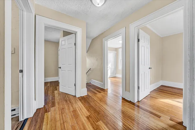 a view of small space with wooden floor and a window