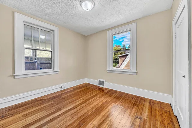 a view of a hallway view with wooden floor and staircase