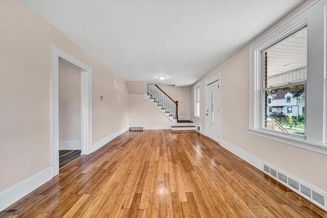 wooden floor in an empty room with a window