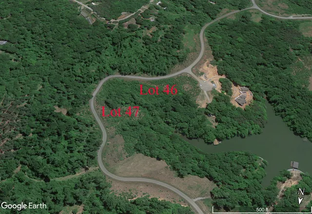 a view of a yard with large trees