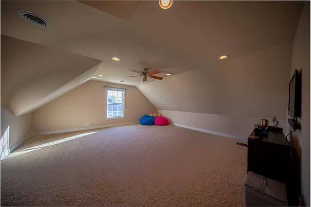 a view of an empty room with a window and a chandelier