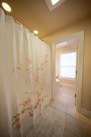 a bathroom with a granite countertop toilet a sink and a mirror