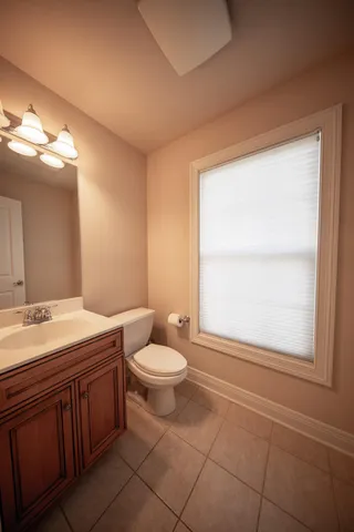 a living room with furniture a flat screen tv and a large window