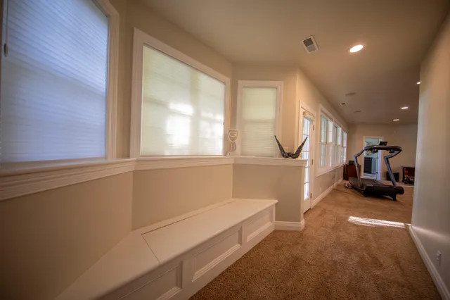 a room with gym equipment and a mirror