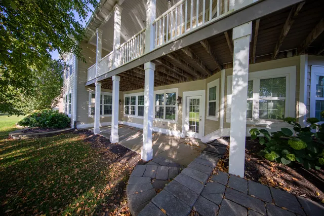 a view of a house with backyard sitting area and garden