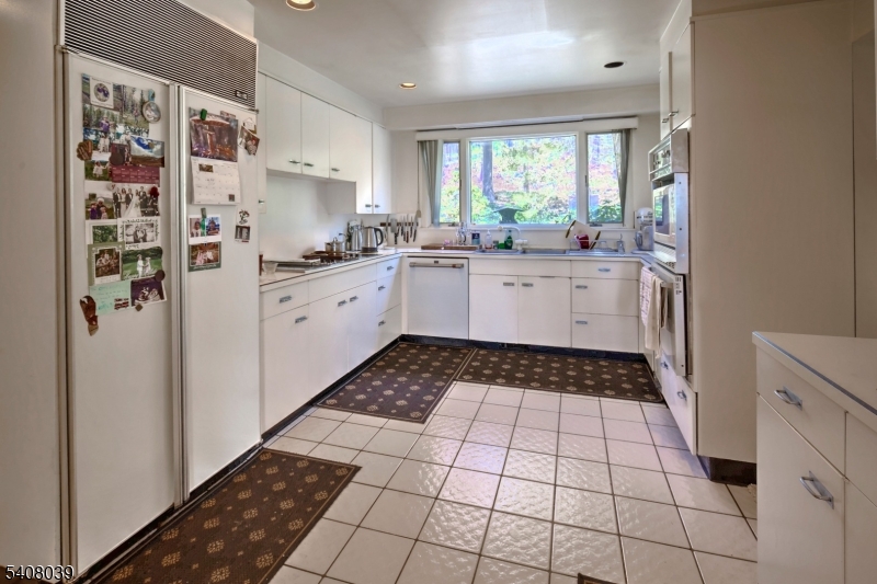 235 Mountainside Road Mendham, NJ 07945 - Photo 12 of 47 a kitchen with stainless steel appliances a refrigerator sink and white cabinets