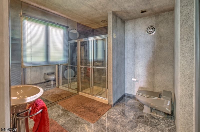 235 Mountainside Road Mendham, NJ 07945 - Photo 23 of 47 a bathroom with a sink toilet and shower