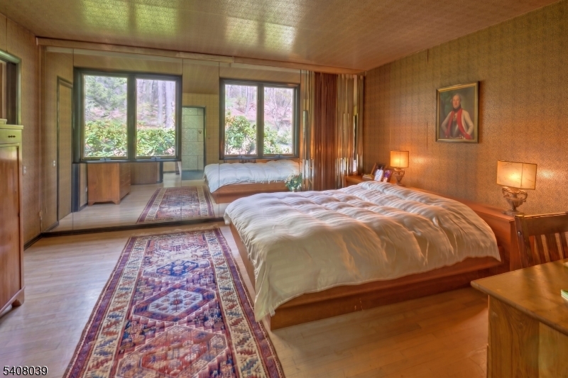 235 Mountainside Road Mendham, NJ 07945 - Photo 24 of 47 a bed sitting in a bedroom next to a window