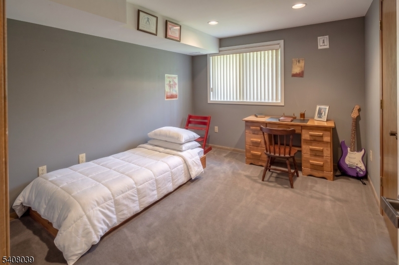 235 Mountainside Road Mendham, NJ 07945 - Photo 29 of 47 a bed room with a bed and a table chair