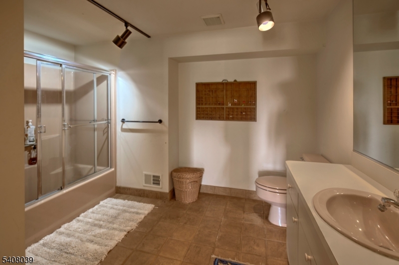235 Mountainside Road Mendham, NJ 07945 - Photo 30 of 47 a bathroom with a sink a toilet and shower