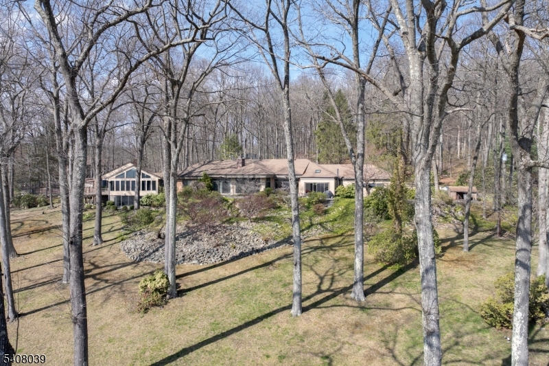 235 Mountainside Road Mendham, NJ 07945 - Photo 34 of 47 a view of a bench in the backyard