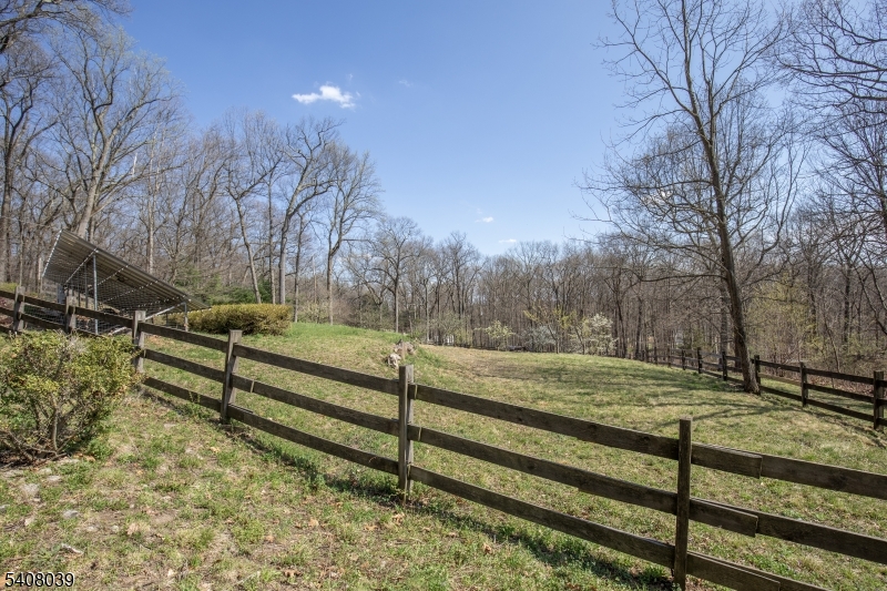 235 Mountainside Road Mendham, NJ 07945 - Photo 41 of 47 a view of a yard with wooden fence