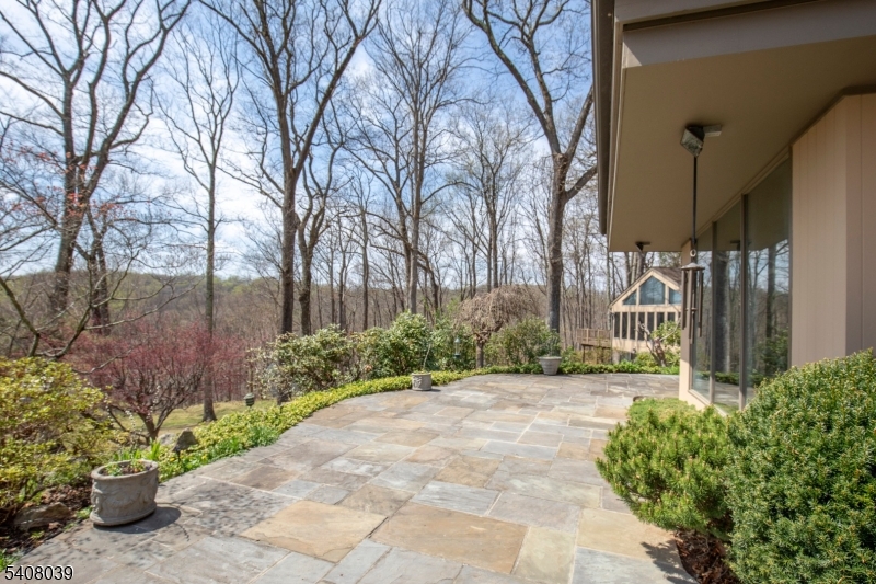 235 Mountainside Road Mendham, NJ 07945 - Photo 6 of 47 a front view of a house with a garden