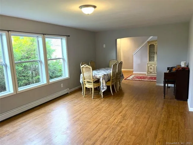 a dining room with furniture and wooden floor