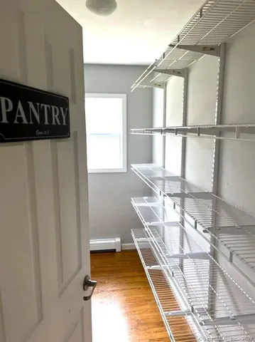 a living room with a couch and a wooden floor