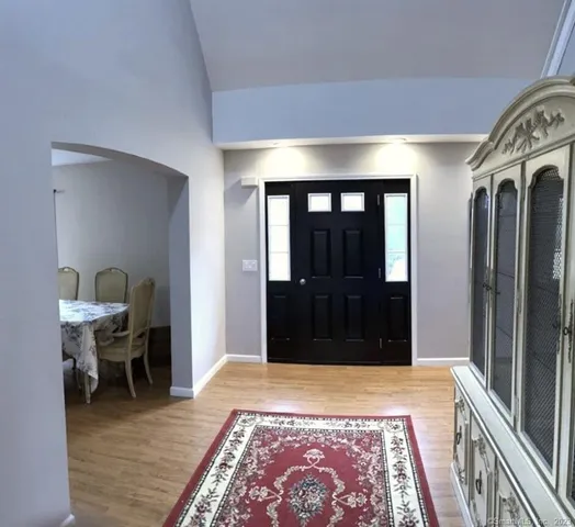 a kitchen with a stove and a wooden floor