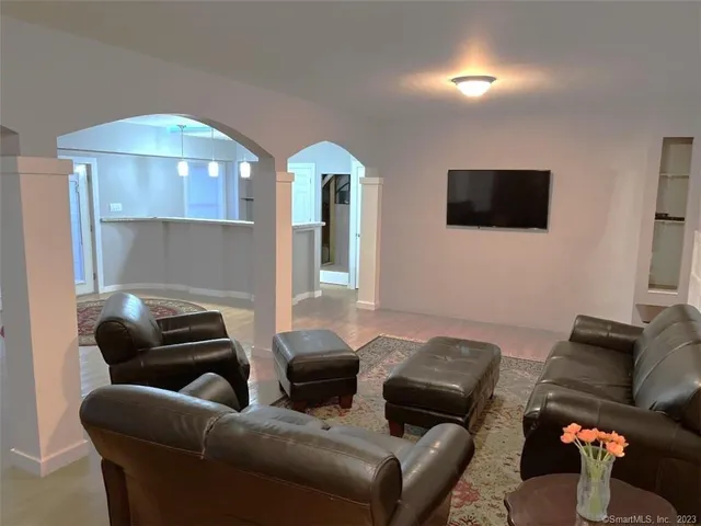 a living room with lots of furniture and a chandelier