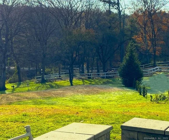 a view of a big yard with a house in the background