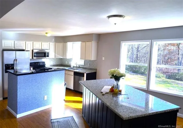 a kitchen with granite countertop lots of counter top space and stainless steel appliances