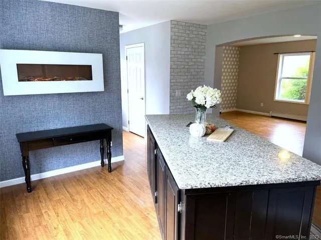 a dining room with table chairs and a fireplace