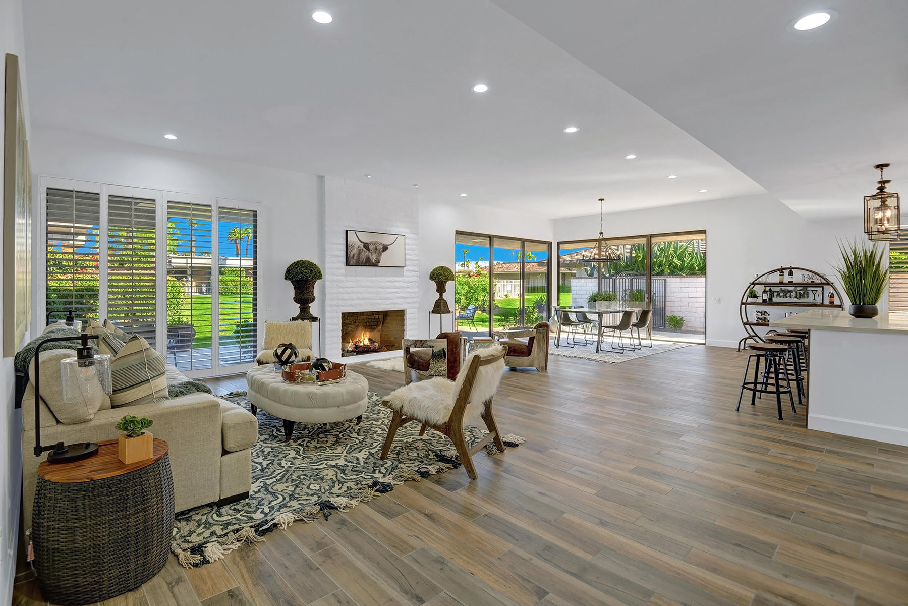 a living room with fireplace furniture and a large window