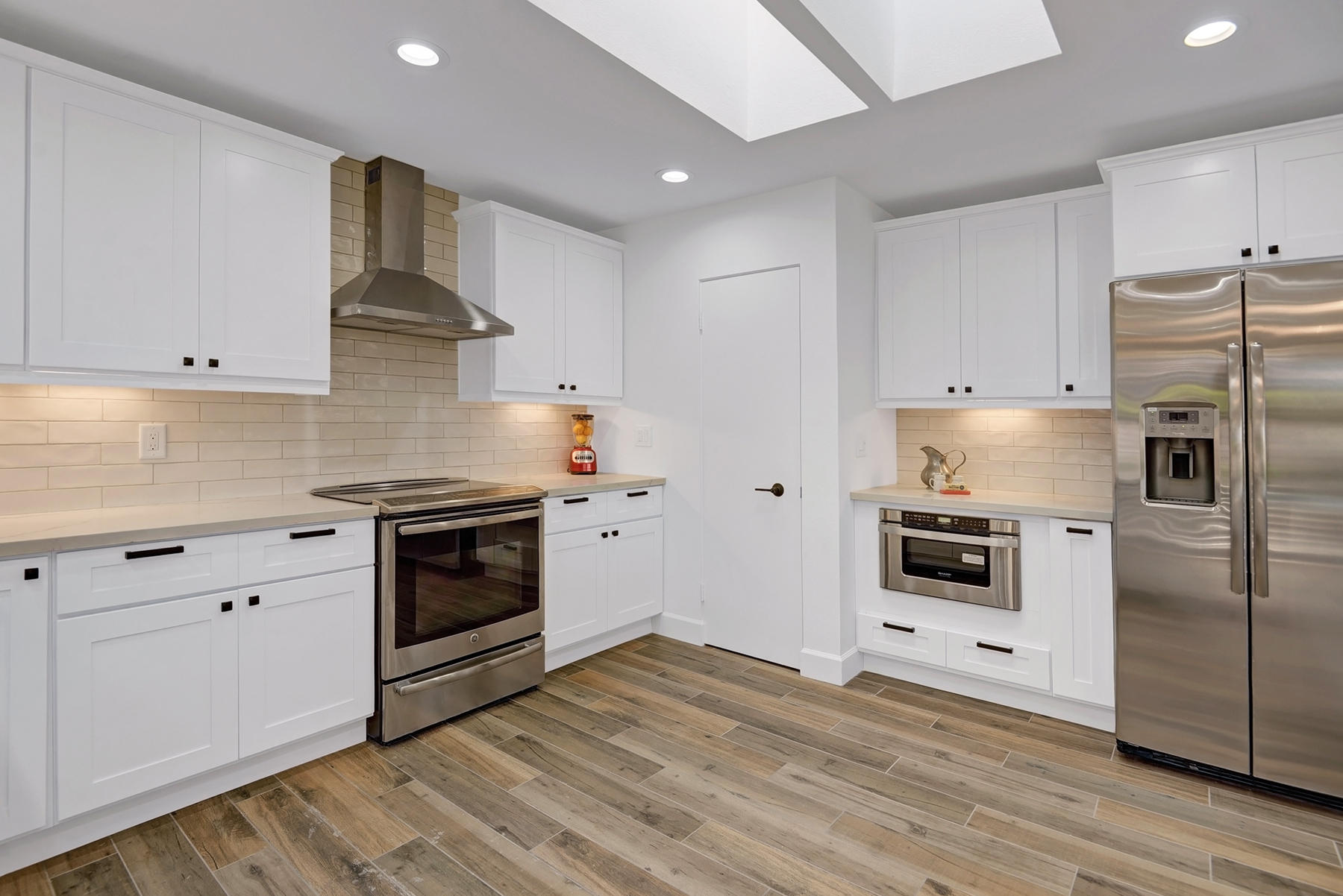 34 Duke Drive Rancho Mirage, CA 92270 - Photo 12 of 32 a kitchen with granite countertop white cabinets and stainless steel appliances