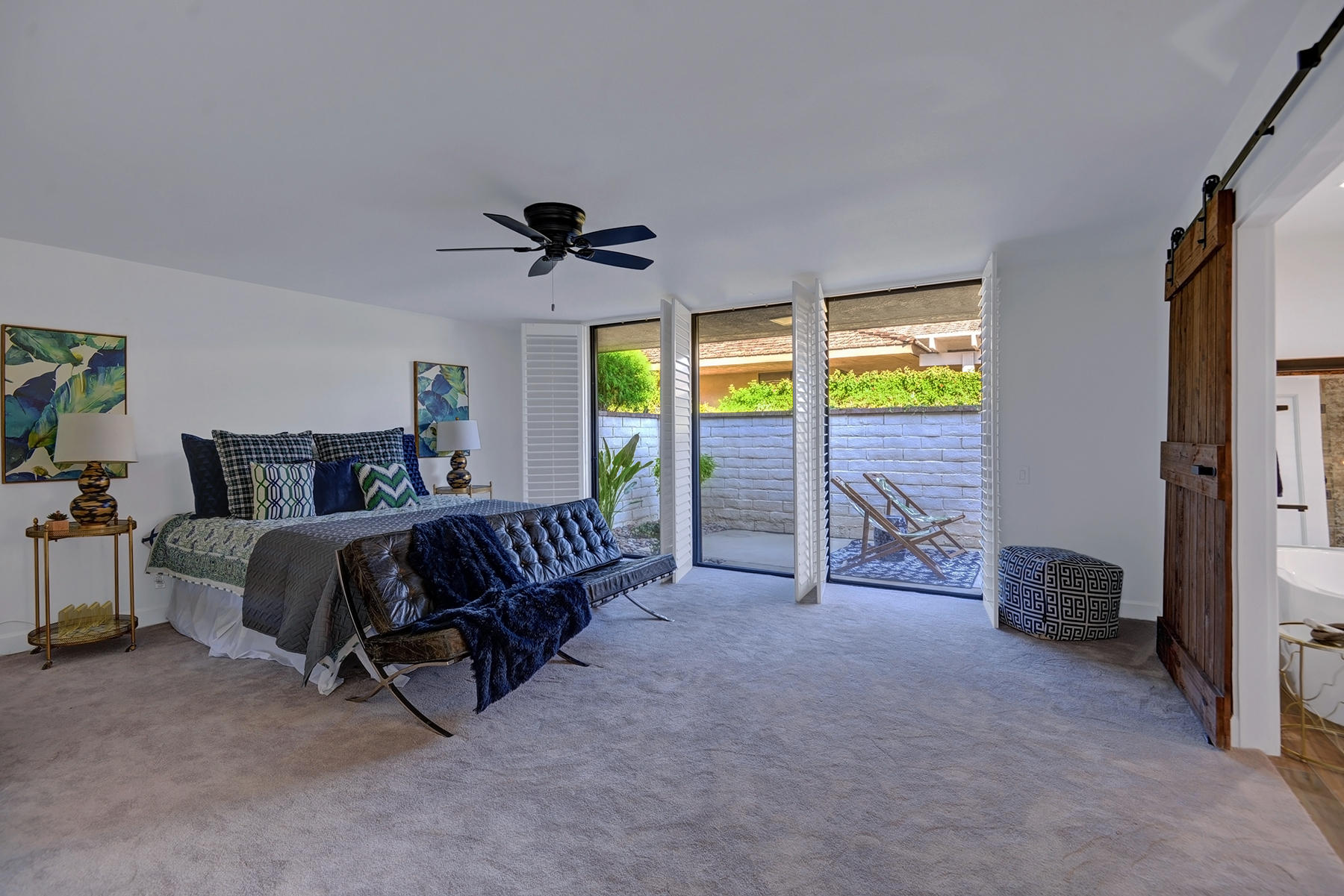 34 Duke Drive Rancho Mirage, CA 92270 - Photo 22 of 32 a bedroom with a bed and a chandelier