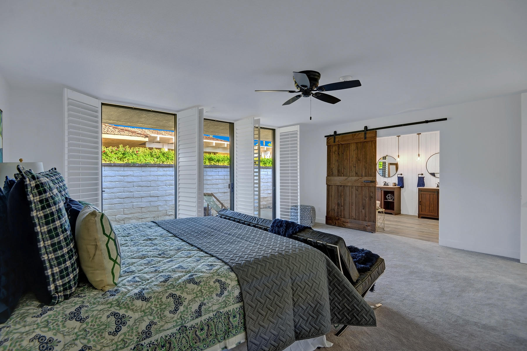 34 Duke Drive Rancho Mirage, CA 92270 - Photo 23 of 32 a spacious bedroom with a bed and a walk in closet