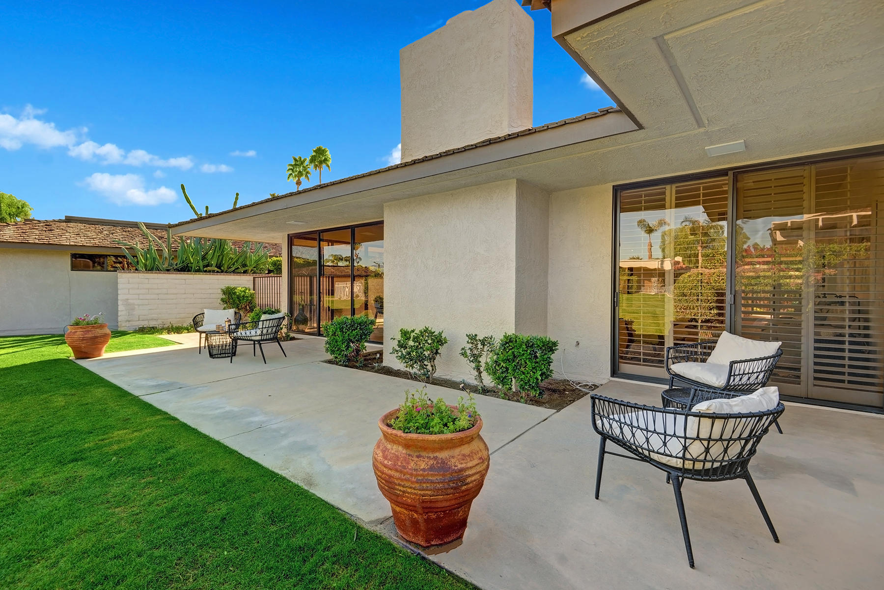 34 Duke Drive Rancho Mirage, CA 92270 - Photo 25 of 32 a backyard of a house with table and chairs