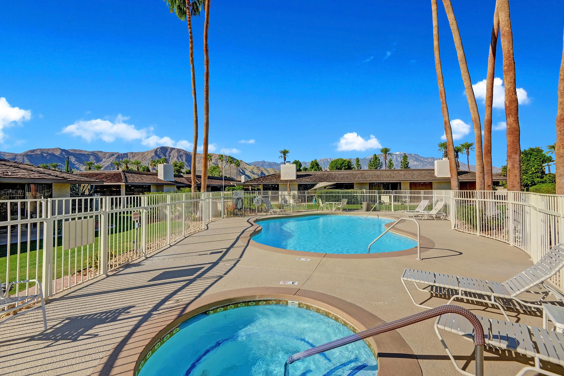 34 Duke Drive Rancho Mirage, CA 92270 - Photo 29 of 32 a view of a swimming pool with a patio and lake view