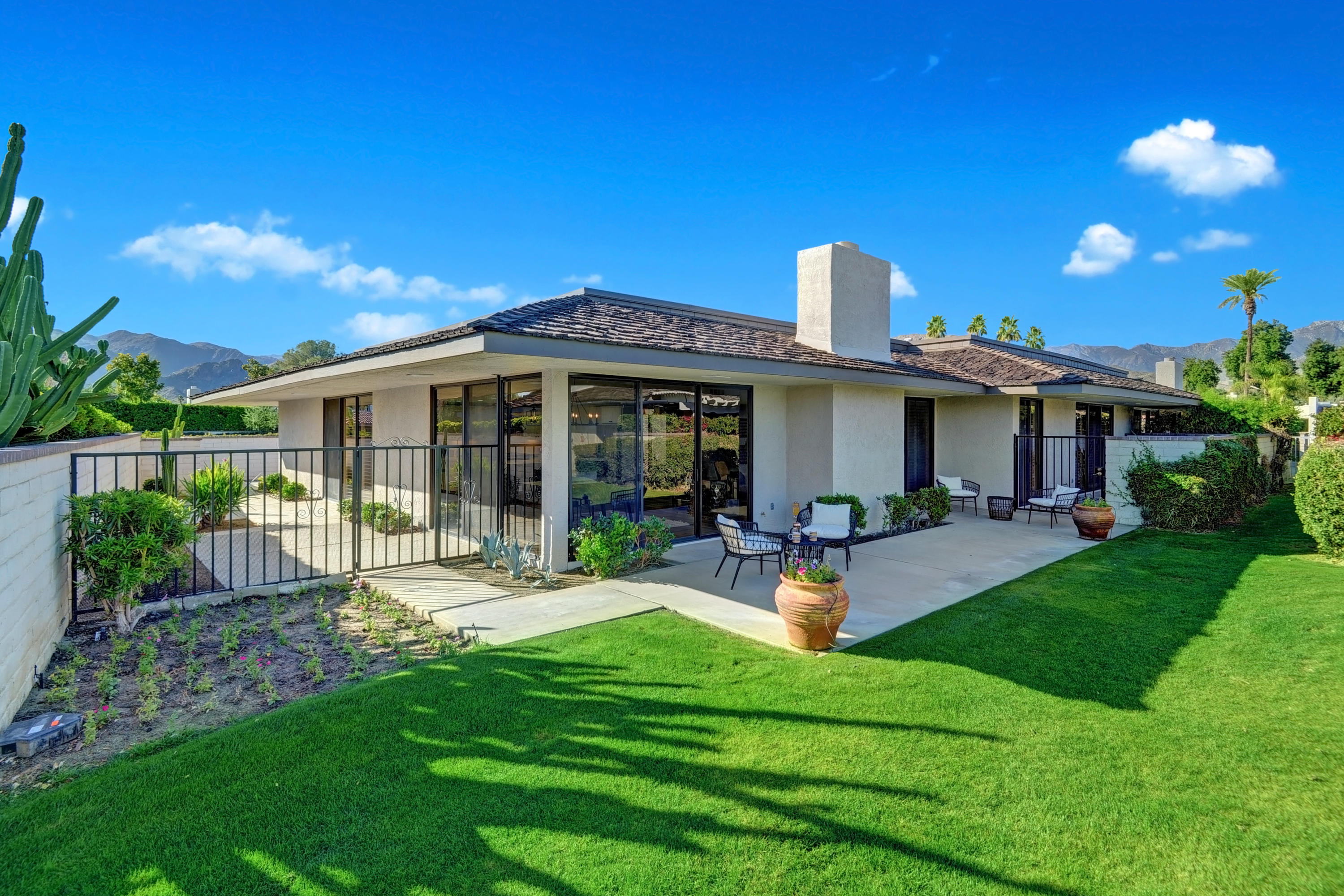 34 Duke Drive Rancho Mirage, CA 92270 - Photo 7 of 32 a front view of a house with garden and porch
