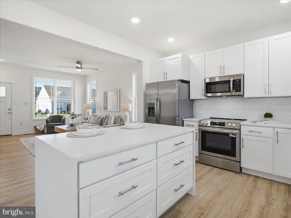a kitchen with a sink stove and refrigerator