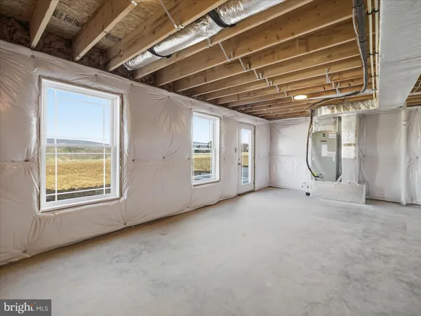 a view of an empty room with chandelier fan