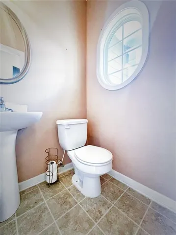 a bathroom with a toilet and a mirror