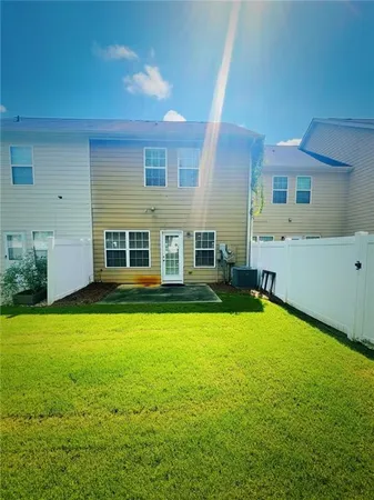 a backyard of a house with table and chairs