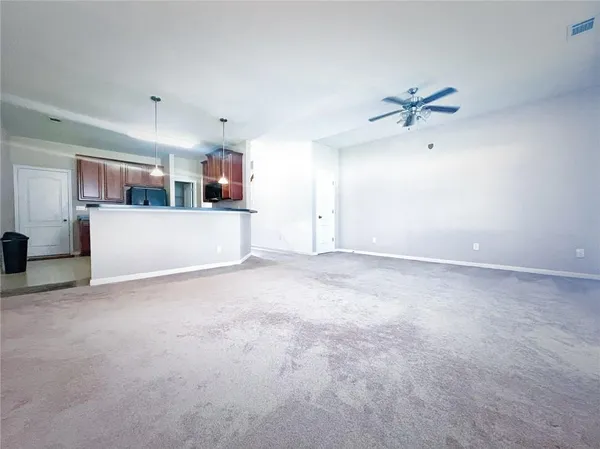a view of a room with a ceiling fan
