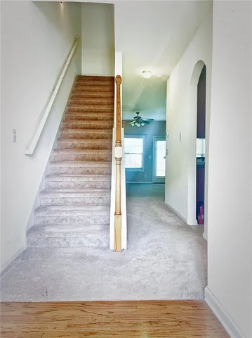 a view of entryway and hall with wooden floor
