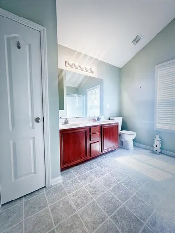 a bathroom with a mirror and a sink