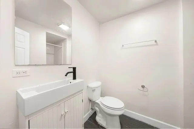 a bathroom with a sink a toilet and mirror