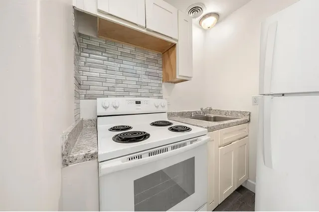 a kitchen with a stove and a refrigerator