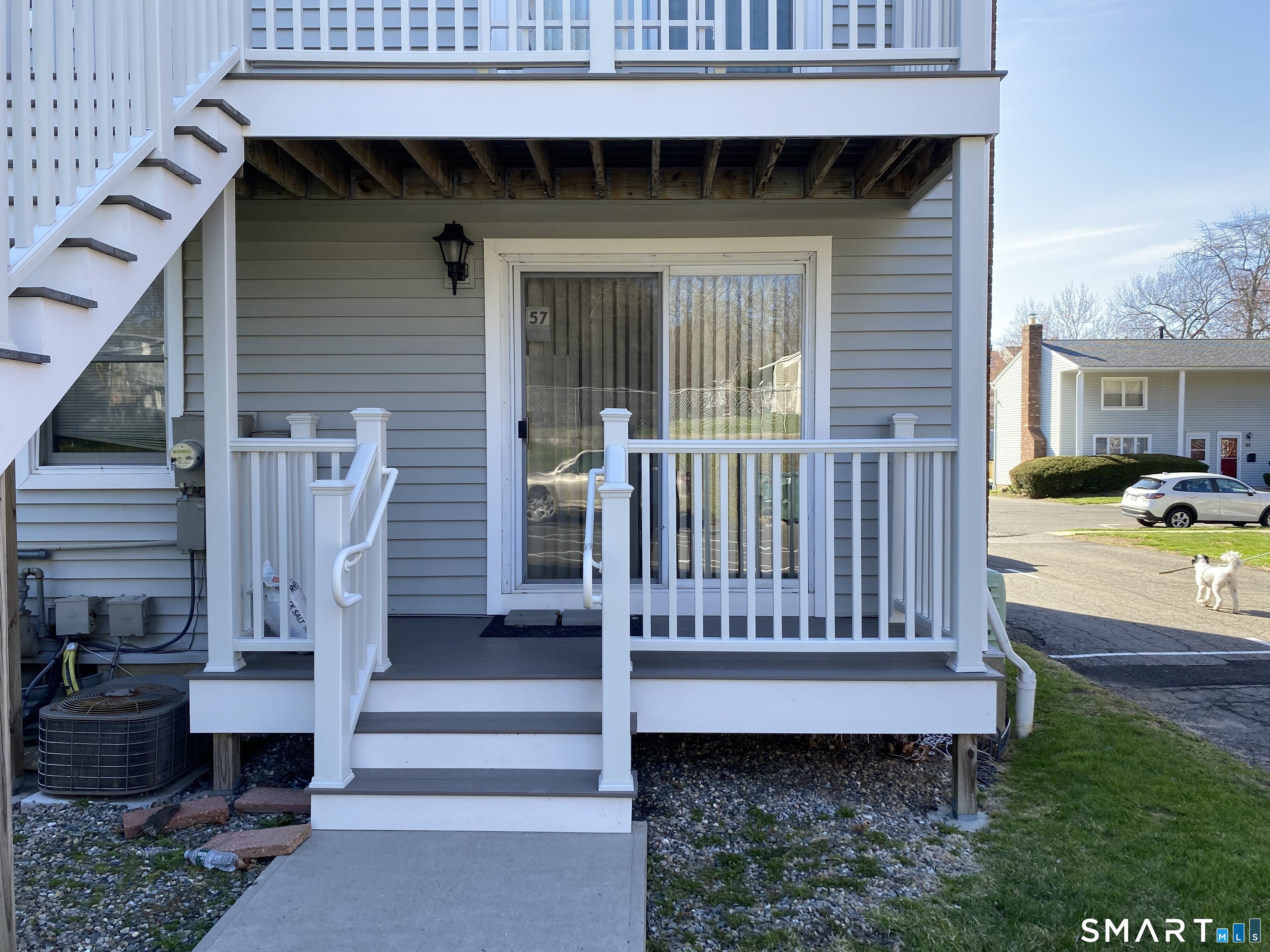 57 Carriage Path South Milford, CT 06460 - Photo 2 of 11 a view of a small house with wooden deck and furniture