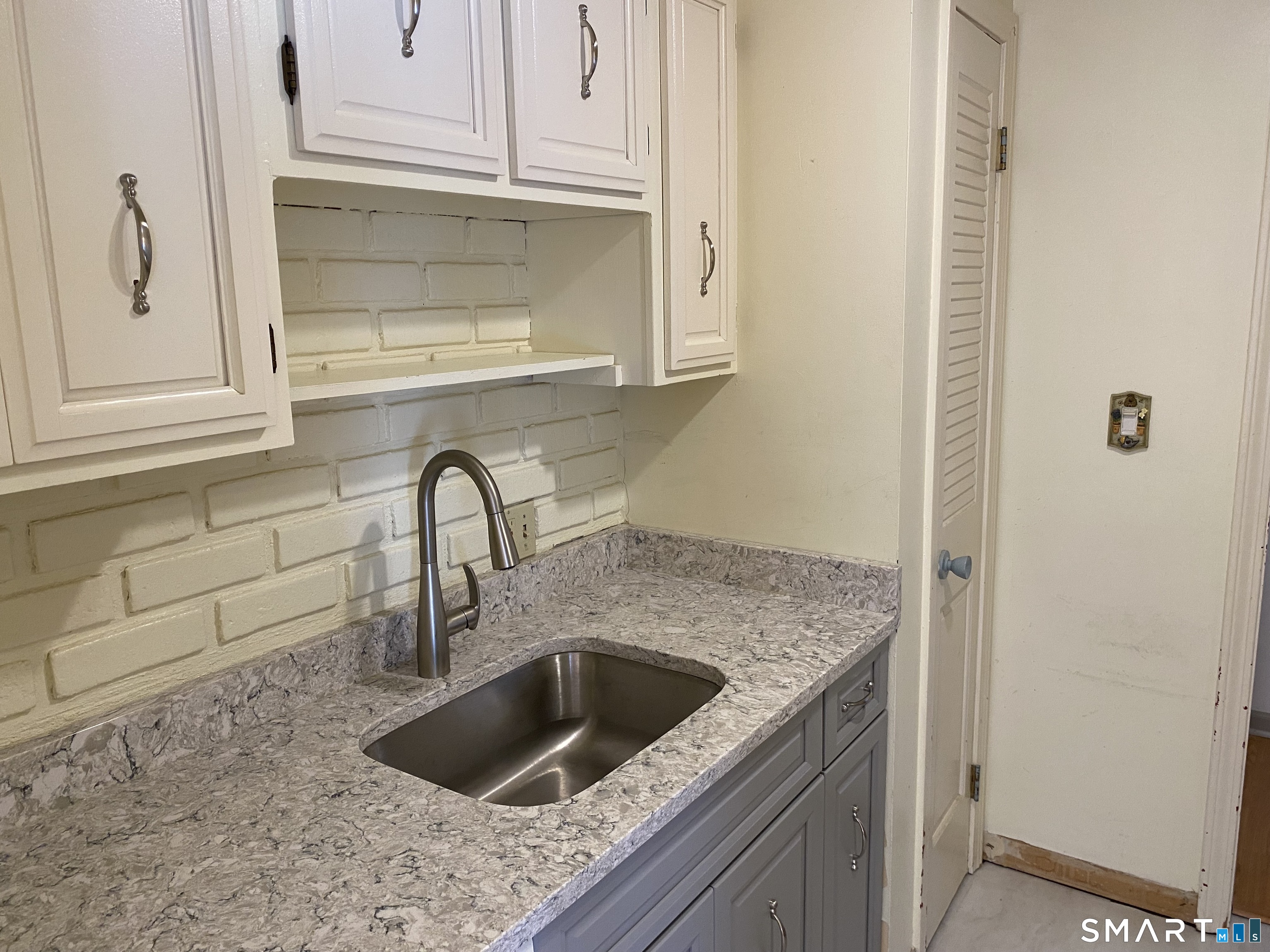 57 Carriage Path South Milford, CT 06460 - Photo 7 of 11 a view with granite countertop a sink and a stove with wooden floor